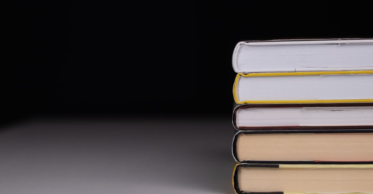 Stack of books lit against a dark background