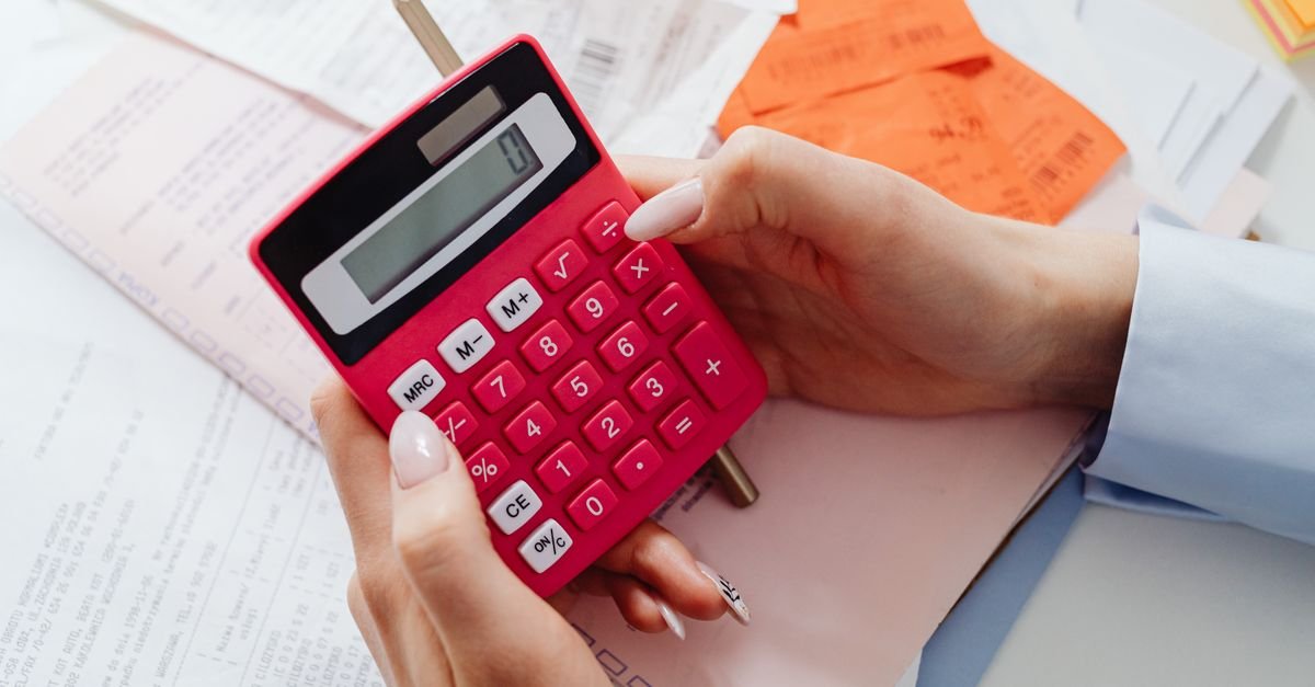 Calculator and notes spread across a desk
