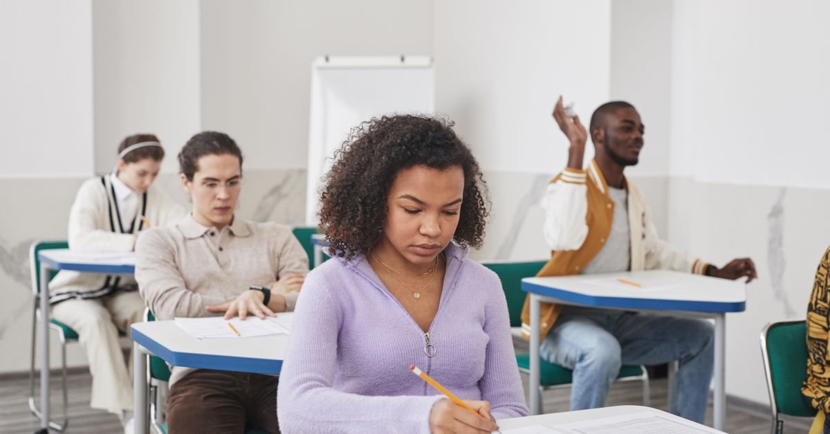 Candidates sitting a written exam in a classroom