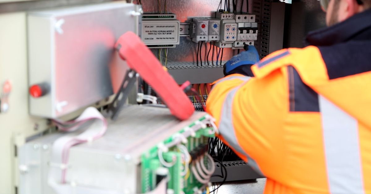 Electrical contractor reviewing plans and permit documents on site