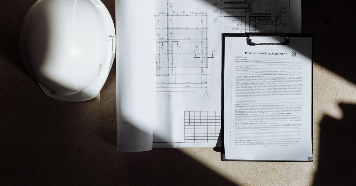 Building plans, a clipboard and a white hard hat, the paperwork a Pasco County contractors license application needs